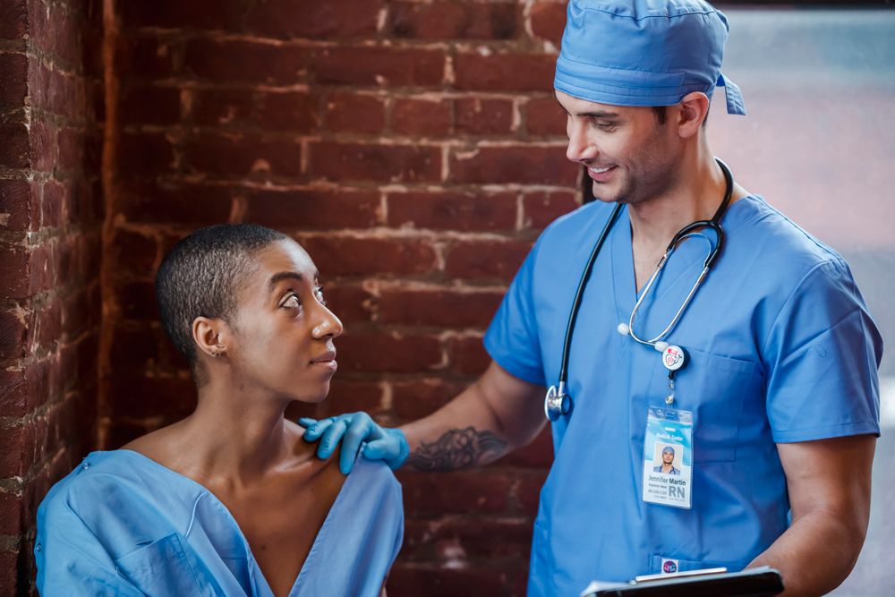 A healthcare professional listening to a patient in a clinic