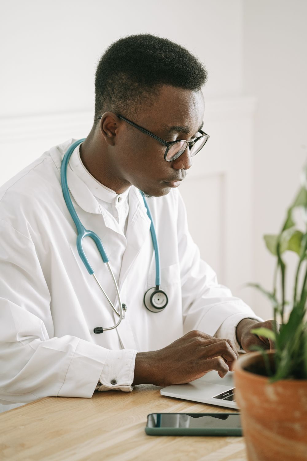 A doctor reviewing information on a laptop